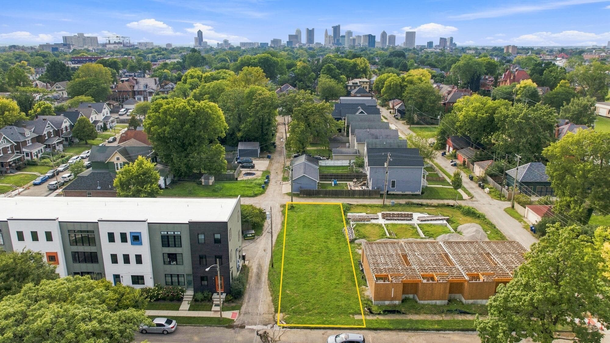 Vacant Development lot featuring a rectangular footprint, urban location, and city skyline backdrop
