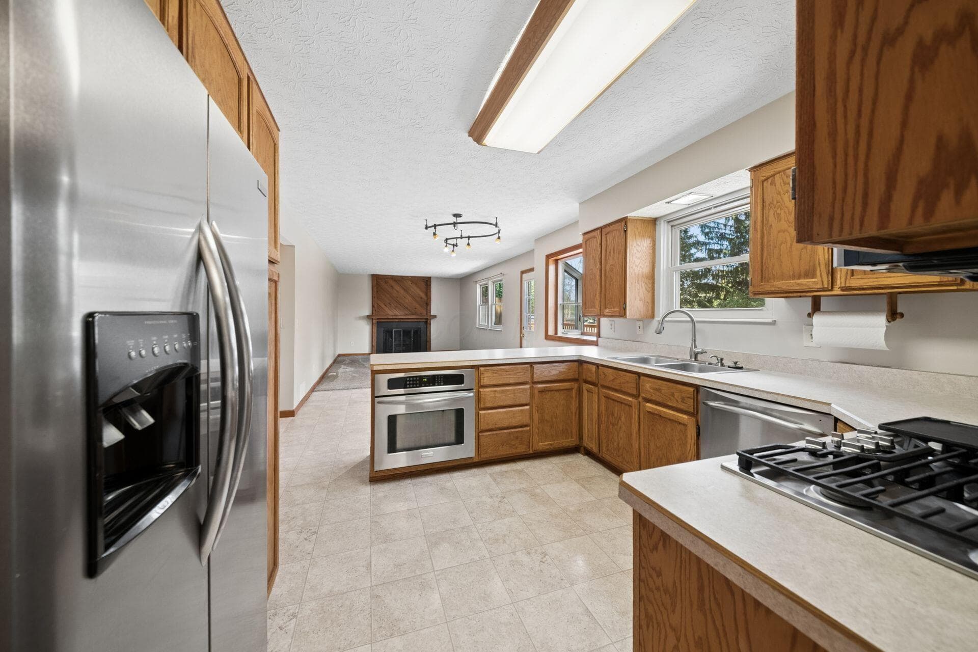 Stainless steel appliances, abundant oak cabinetry, and convenient access to the adjoining family room.