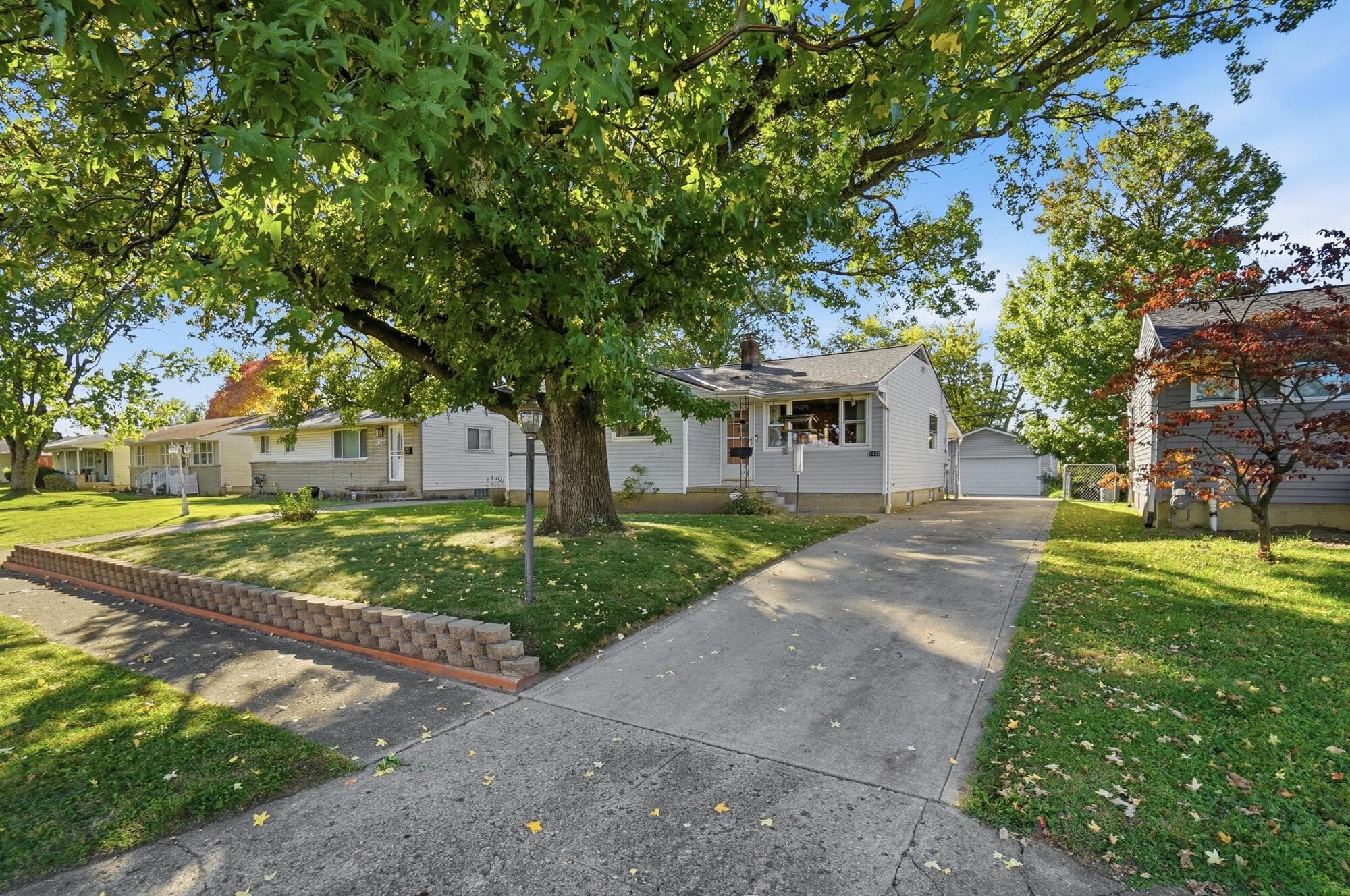 A long driveway leads straight back to the oversized garage.