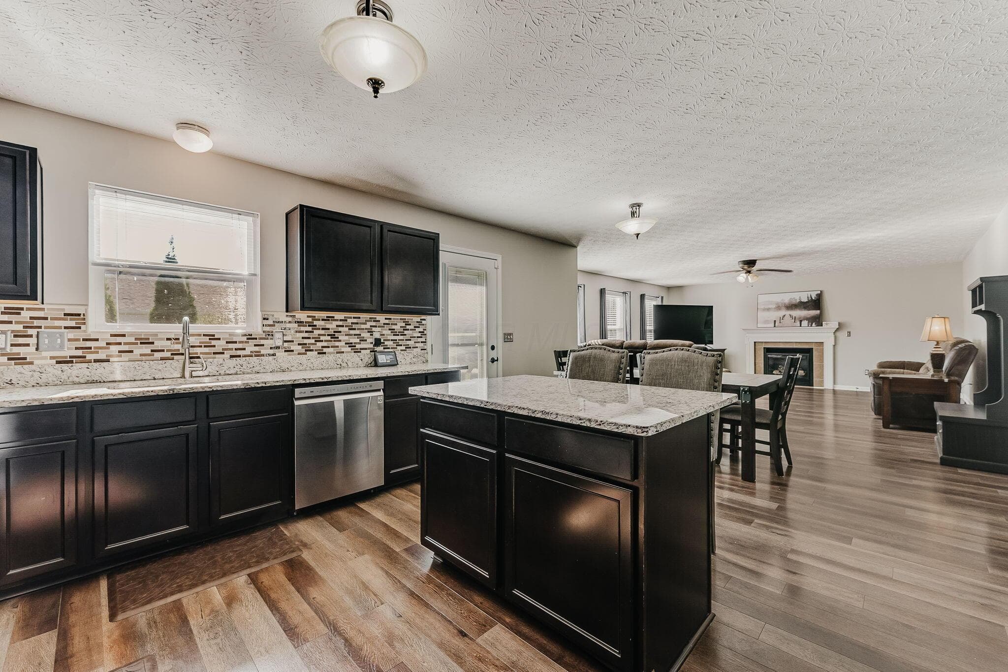 An open kitchen and great room make it easy to stay connected, whether entertaining or enjoying an ordinary evening at home.