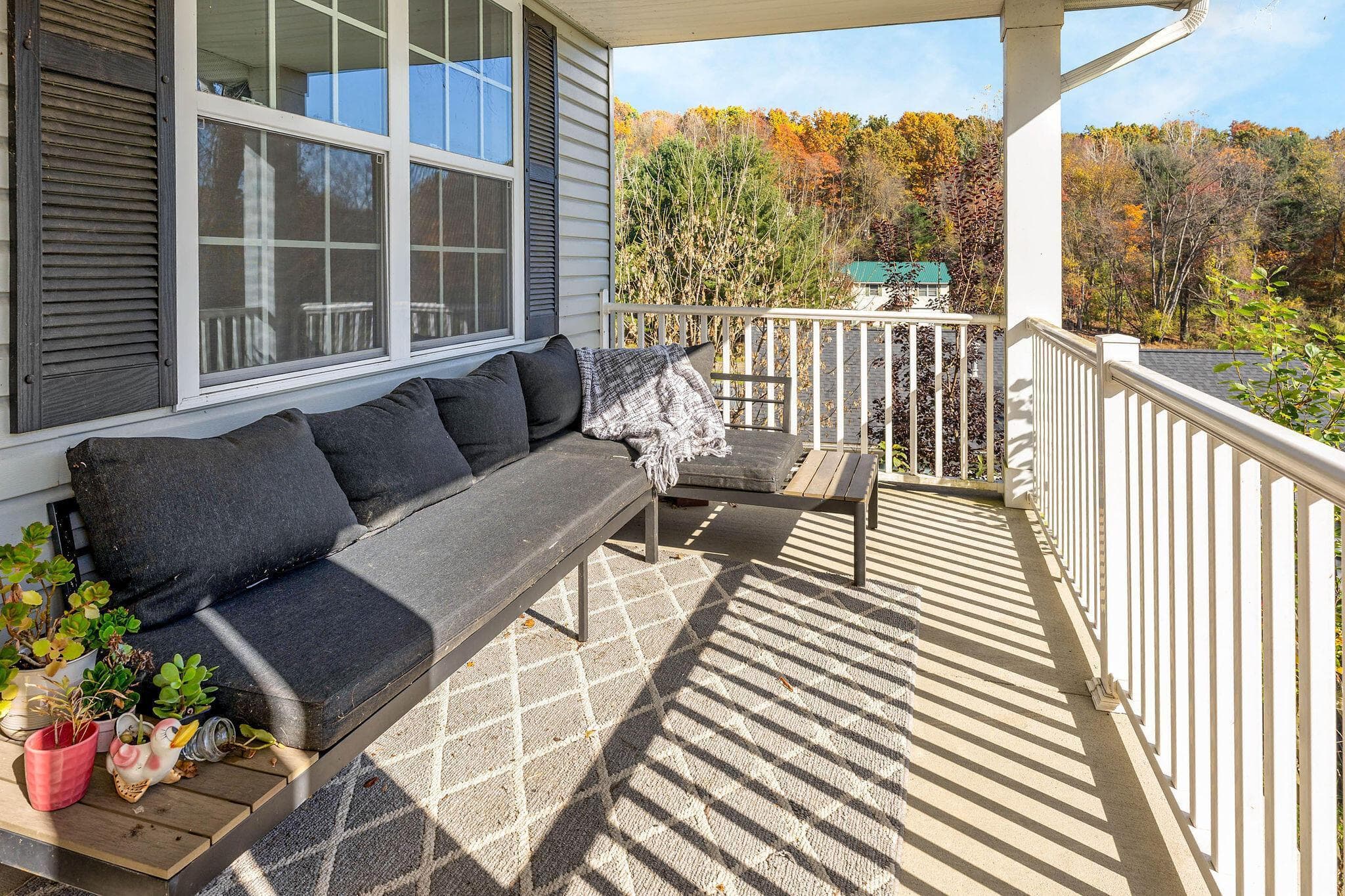The sunbathed covered front porch is a perfect perch to watch the fall color put on a show!