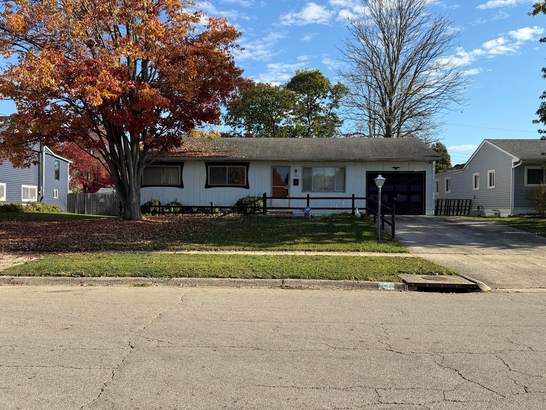 Front view of 900 Olympia Drive, a 3-bedroom, 1-bath ranch in Hamilton Meadows, within Hamilton Local School District. Mature trees frame the yard of this longtime family-owned home, featuring a full basement and renovation potential. Offered AS IS.
