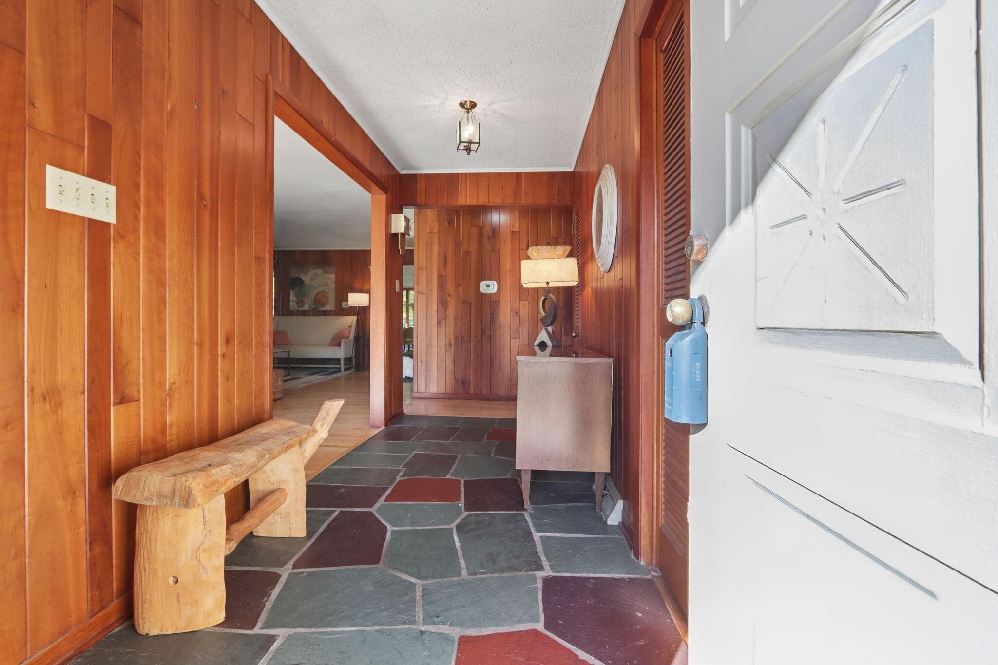 Entry with walnut wood paneling