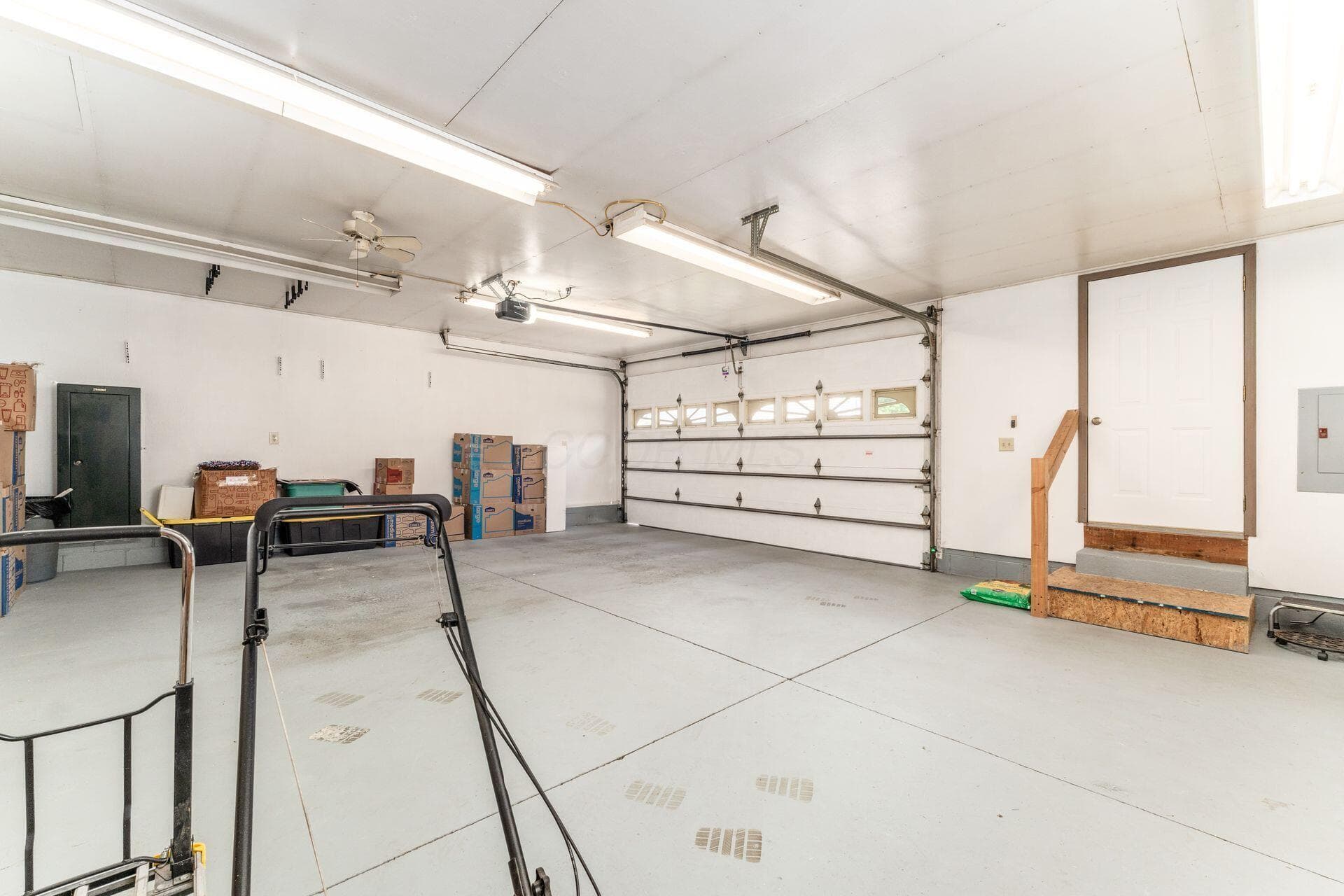 Oversized garage with double door and work bench